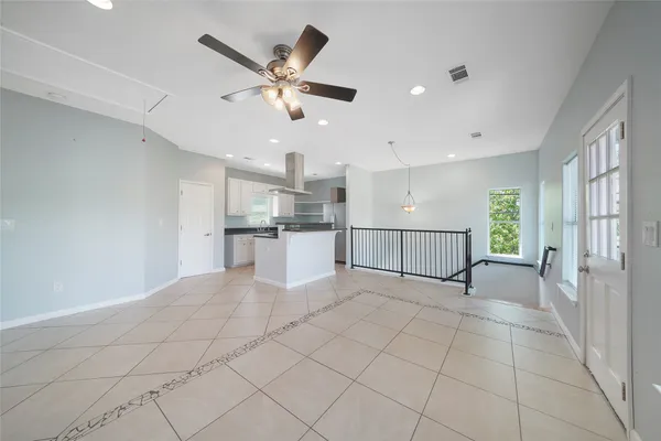a view of a livingroom with a ceiling fan and window