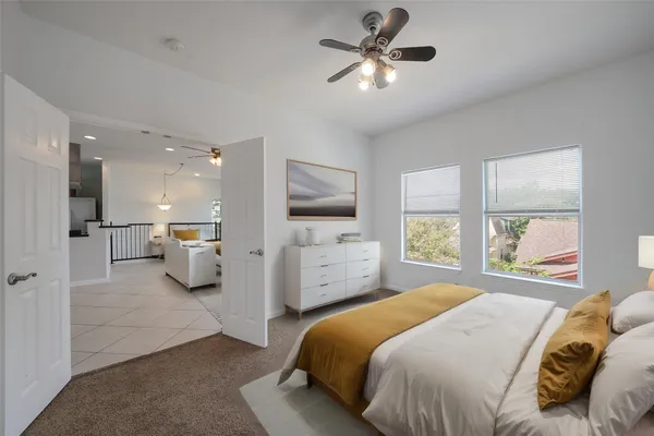 a bedroom with a large bed and a tv