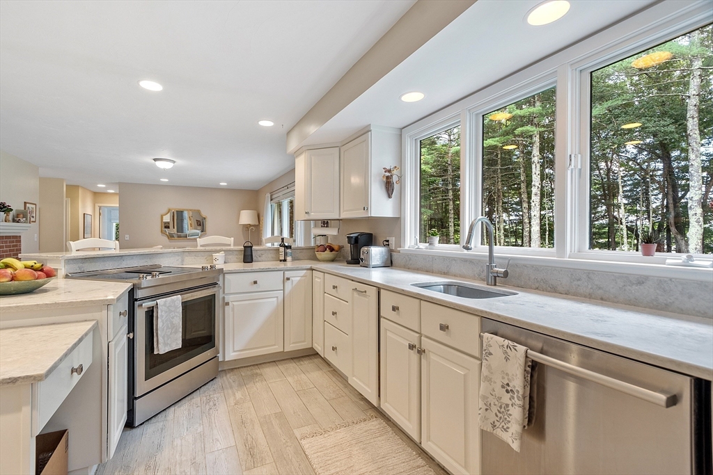 72 Finn Road Harvard, MA 01451 - Photo 12 of 40 a kitchen with white cabinets appliances and a large window