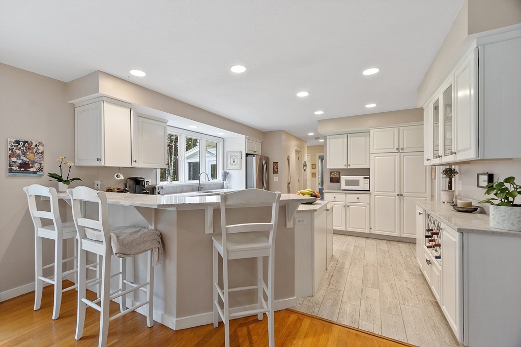 72 Finn Road Harvard, MA 01451 - Photo 15 of 40 a kitchen with stainless steel appliances granite countertop a table chairs refrigerator and microwave