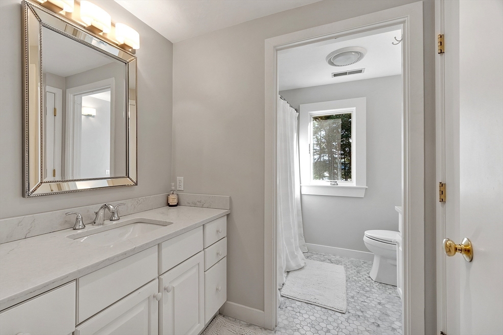 72 Finn Road Harvard, MA 01451 - Photo 25 of 40 a bathroom with a sink a toilet and a mirror