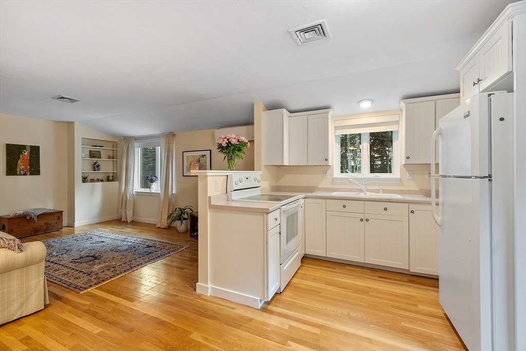 72 Finn Road Harvard, MA 01451 - Photo 30 of 40 a kitchen with white cabinets and wooden floor