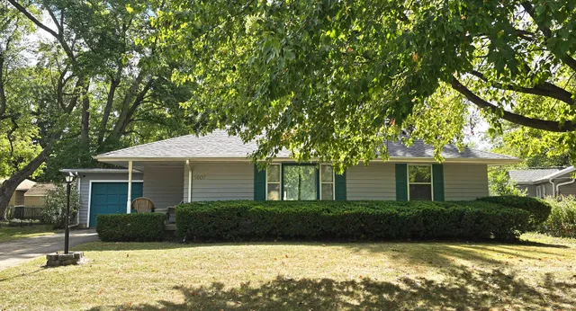 a front view of a house with yard and green space