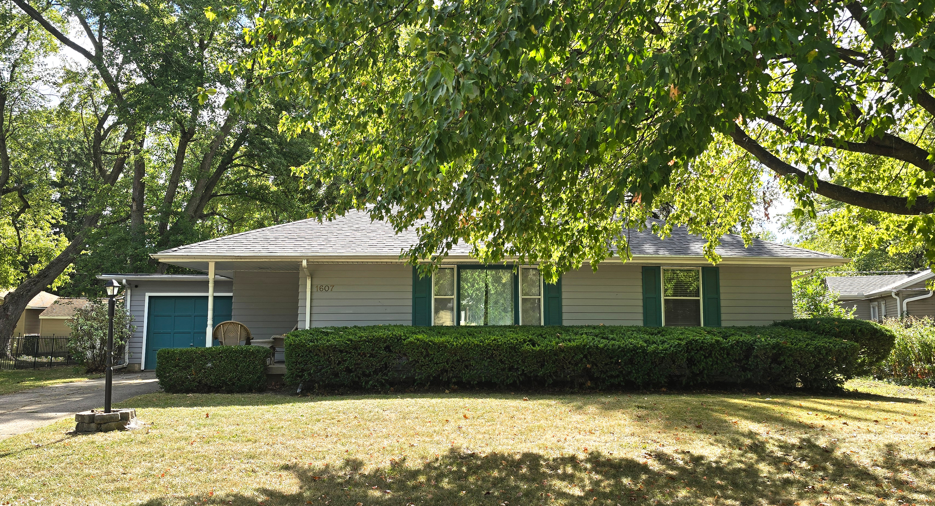 a front view of a house with yard and green space