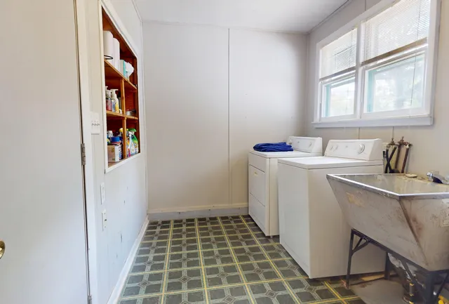 a bathroom with a sink toilet and window