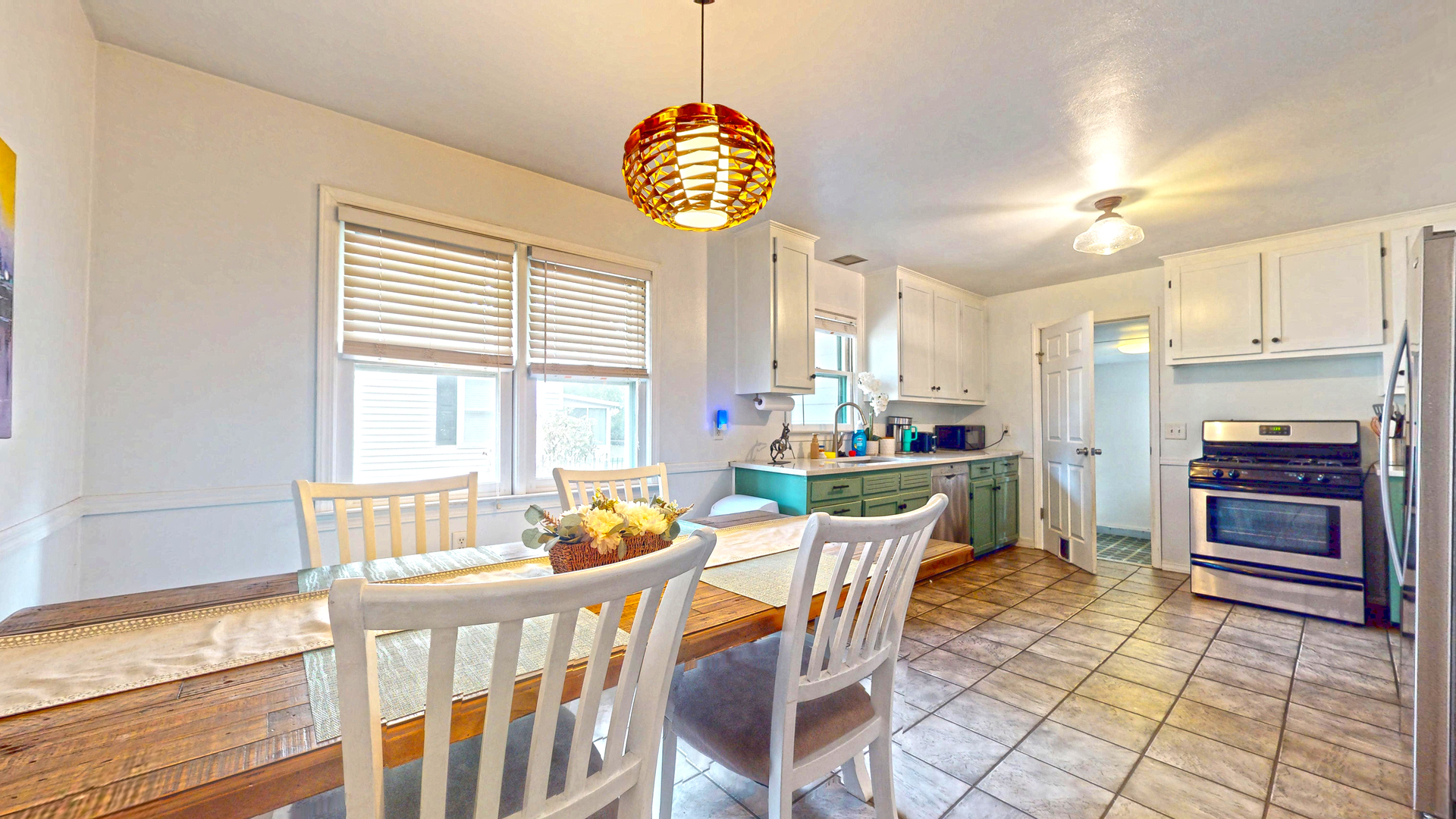 1607 West William Street Champaign, IL 61821 - Photo 6 of 14 a dining room with furniture a chandelier and wooden floor