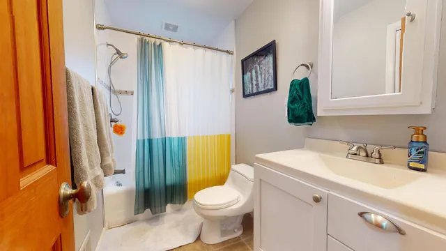 a bathroom with a sink toilet and shower