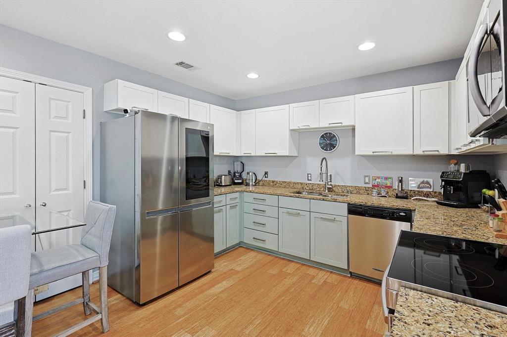 2722 Knight Street, Unit 232A Dallas, TX 75219 - Photo 13 of 24 a kitchen with granite countertop a refrigerator stove top oven and sink