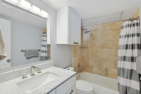 a bathroom with a sink shower bathtub and a mirror