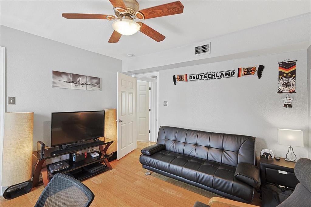 2722 Knight Street, Unit 232A Dallas, TX 75219 - Photo 22 of 24 a living room with furniture and a flat screen tv