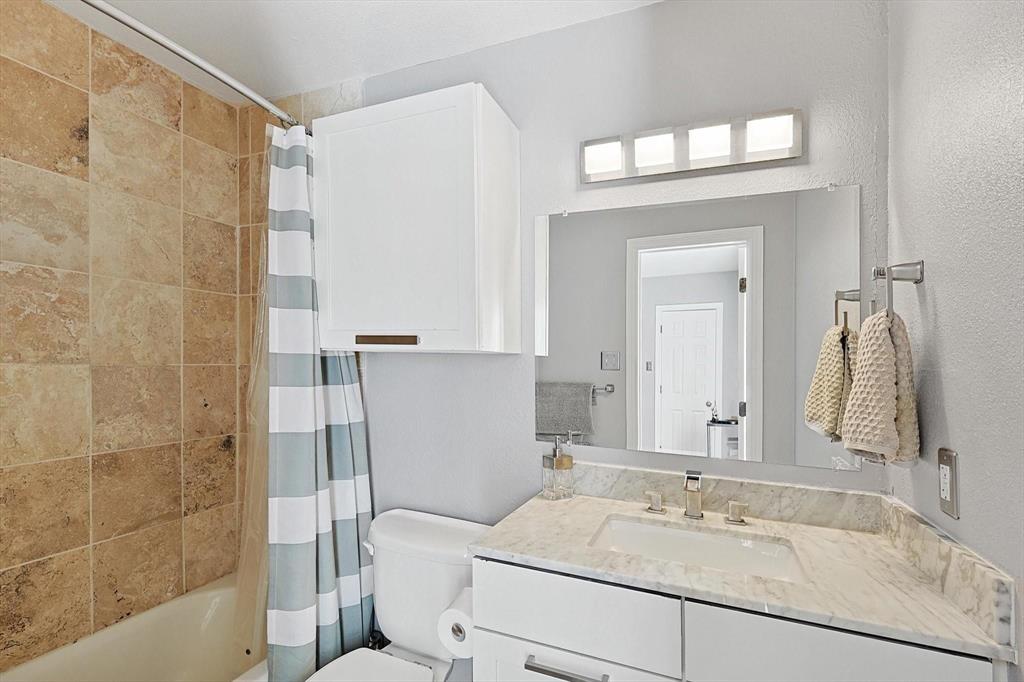2722 Knight Street, Unit 232A Dallas, TX 75219 - Photo 23 of 24 a bathroom with a sink vanity granite tub and shower