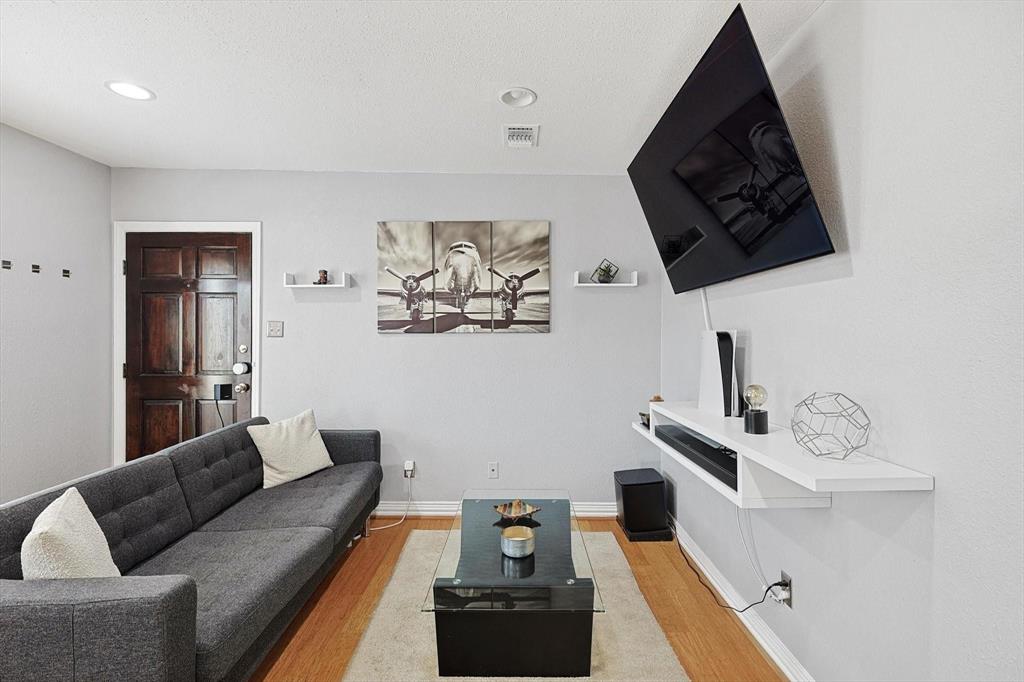 2722 Knight Street, Unit 232A Dallas, TX 75219 - Photo 6 of 24 a living room with furniture and wooden floor