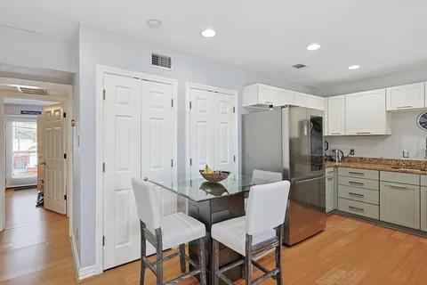 a dining room with furniture and wooden floor