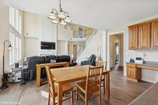 a view of a dining room with furniture a chandelier and wooden floor