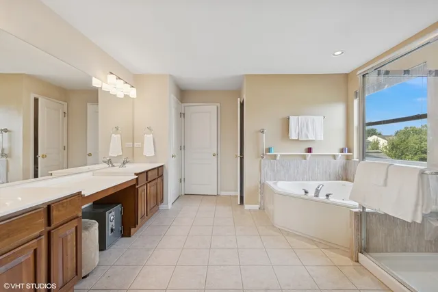 a large en suite bathroom with a tub sink and mirror
