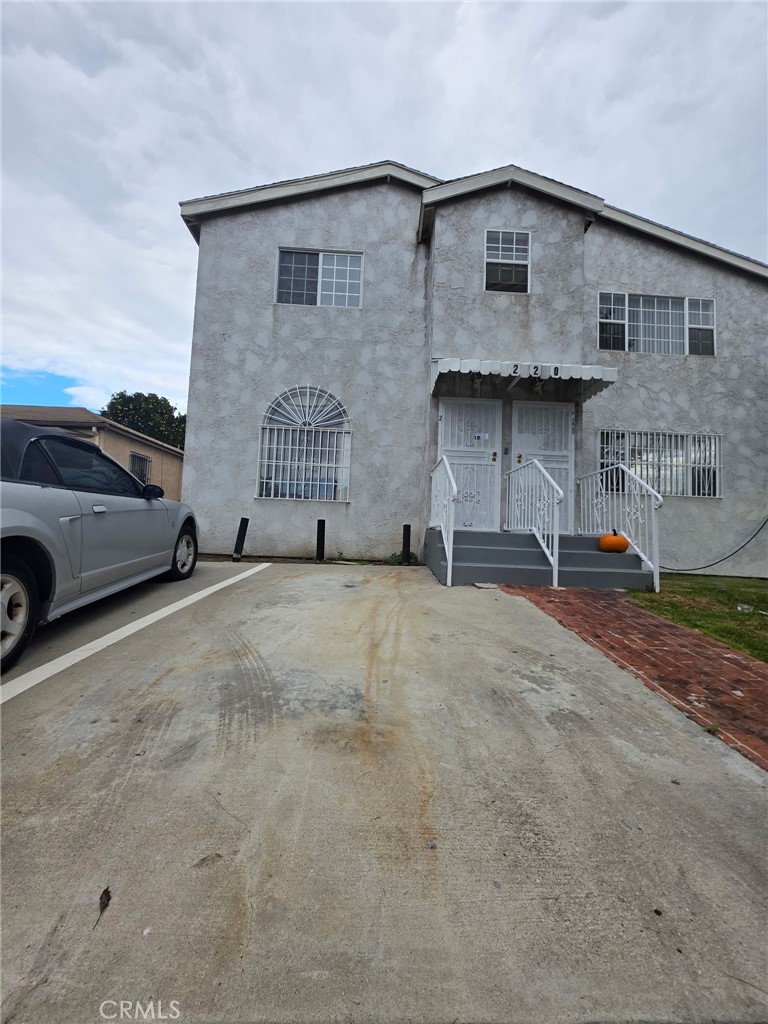 a view of building with car parked