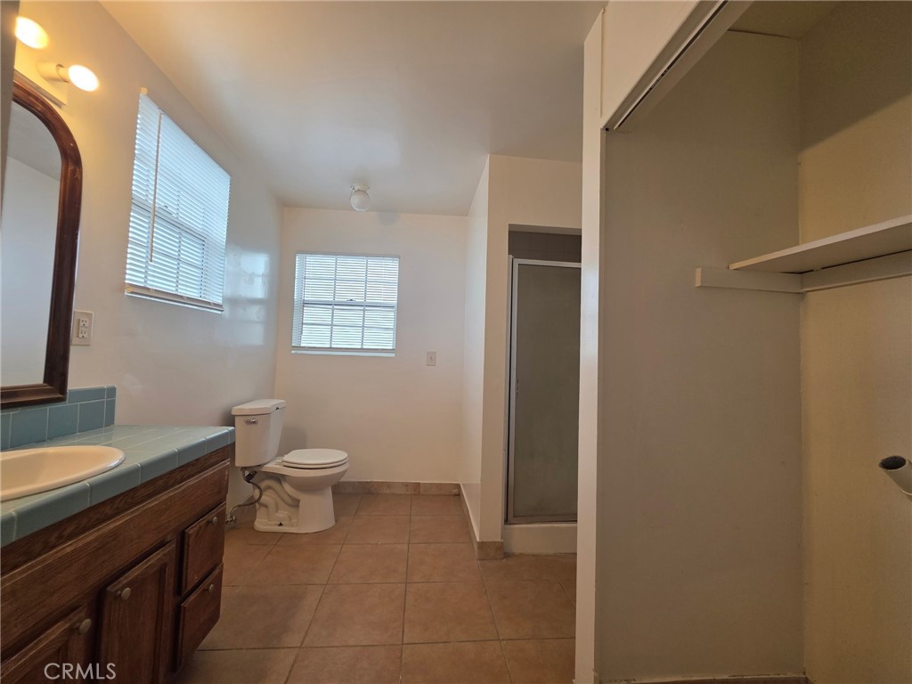220 South Pannes Avenue, Unit 1 Compton, CA 90221 - Photo 11 of 15 a bathroom with a toilet a sink and mirror