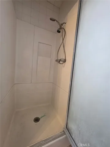 a bathroom with a glass door shower