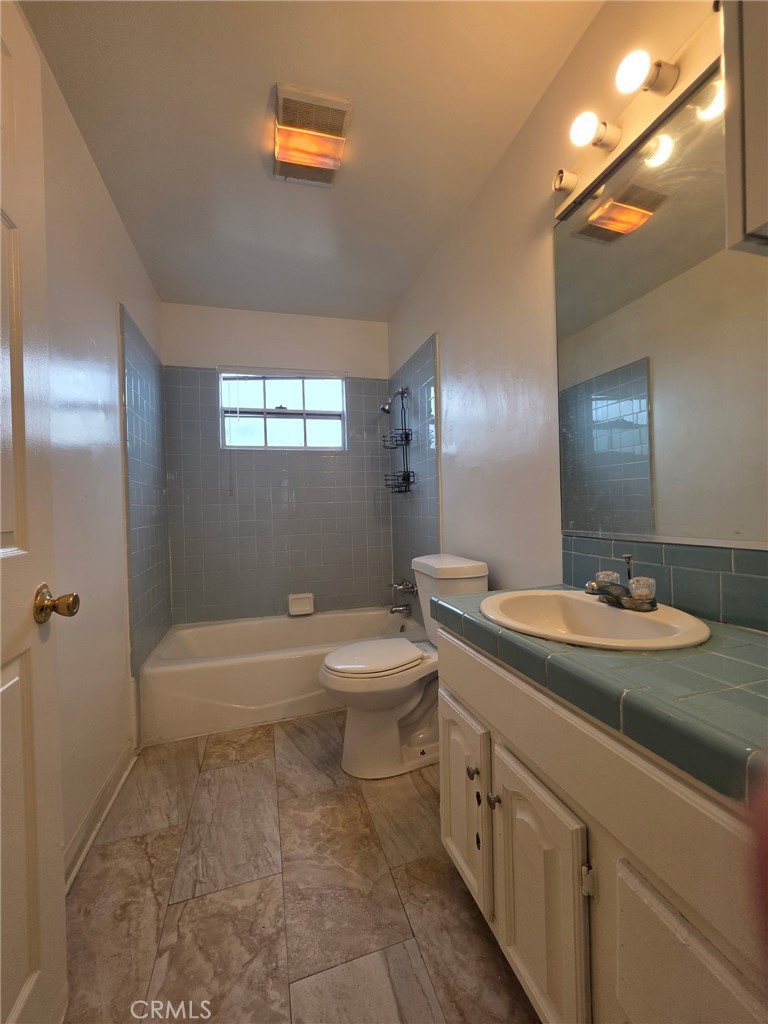 220 South Pannes Avenue, Unit 1 Compton, CA 90221 - Photo 14 of 15 a bathroom with a sink a toilet and shower