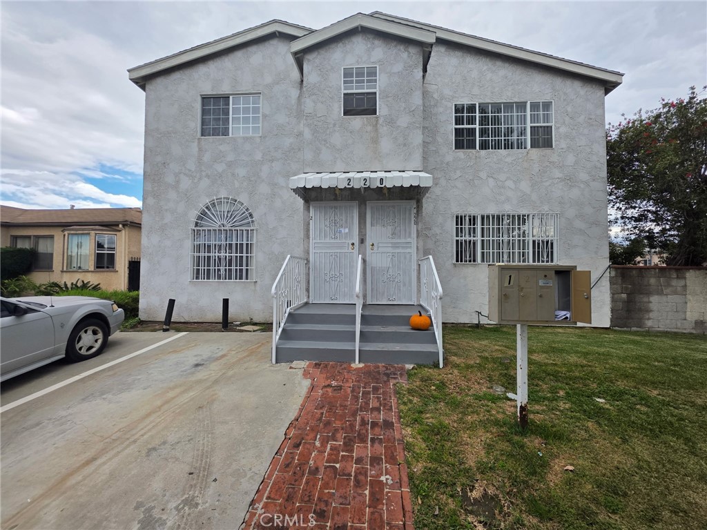 220 South Pannes Avenue, Unit 1 Compton, CA 90221 - Photo 2 of 15 a view of a house with a yard and parking space