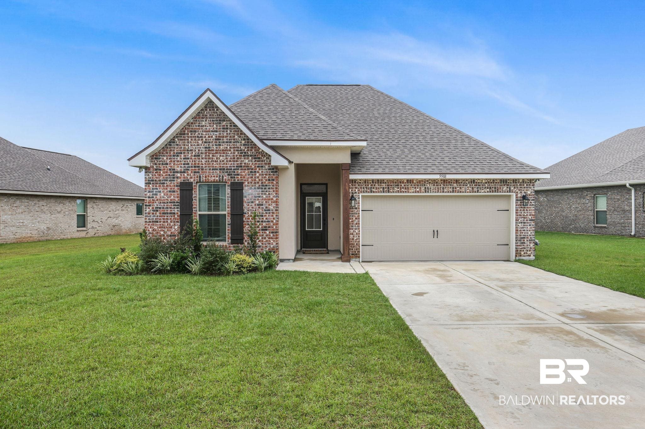 9988 Chipper Lane Foley, AL 36535 - Photo 1 of 26 View of front of home with a front lawn and a garage