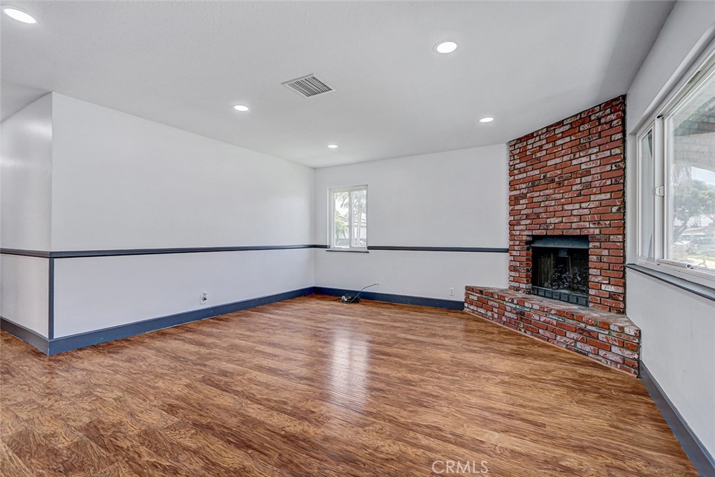 15232 Purdy Street Westminster, CA 92683 - Photo 12 of 31 a view of an empty room with wooden floor and a fireplace