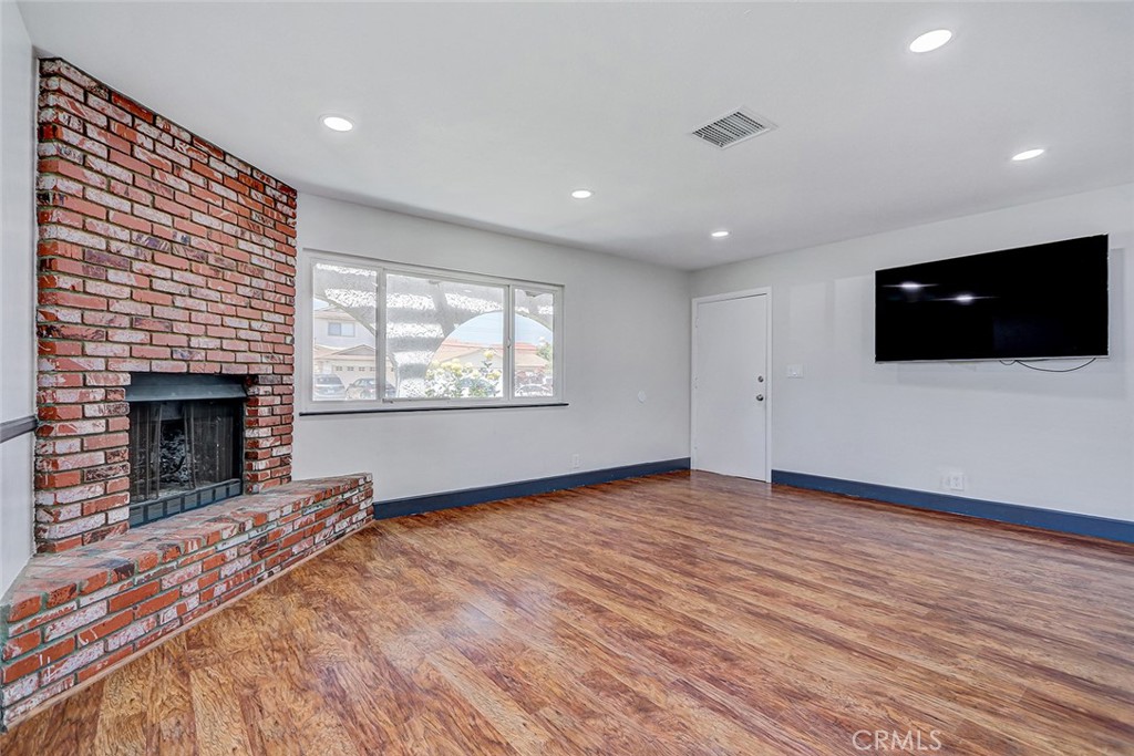 15232 Purdy Street Westminster, CA 92683 - Photo 13 of 31 a view of empty room with wooden floor and fireplace
