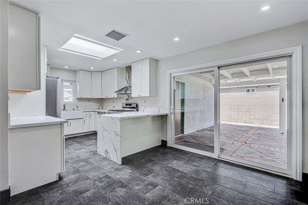 15232 Purdy Street Westminster, CA 92683 - Photo 16 of 31 a kitchen with white cabinets and white appliances