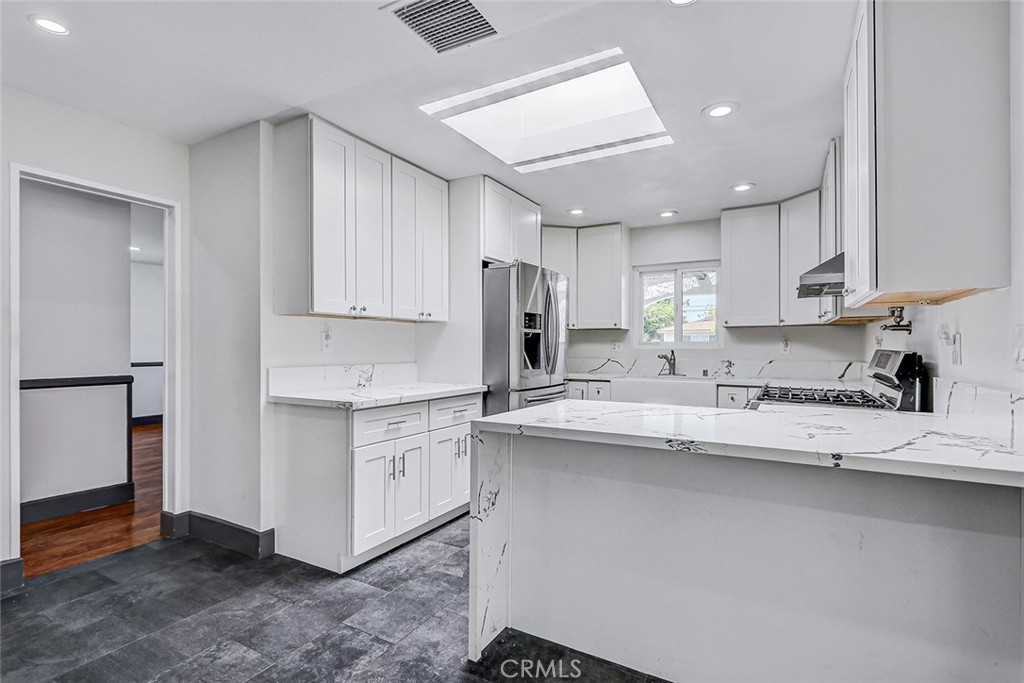 15232 Purdy Street Westminster, CA 92683 - Photo 17 of 31 a kitchen with stainless steel appliances granite countertop a sink stove and refrigerator
