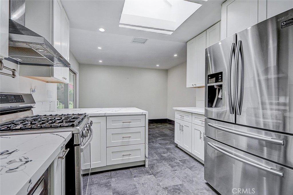 15232 Purdy Street Westminster, CA 92683 - Photo 18 of 31 a kitchen with a refrigerator stove and cabinets
