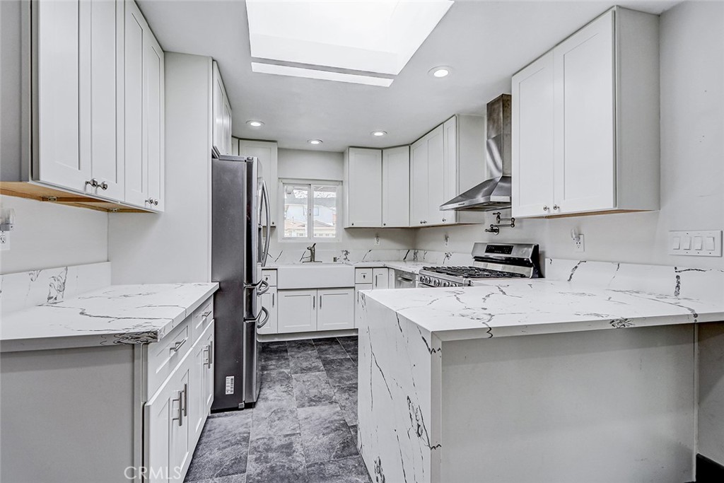 15232 Purdy Street Westminster, CA 92683 - Photo 2 of 31 a kitchen with a sink stove and refrigerator