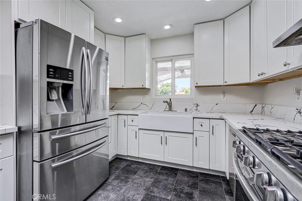 15232 Purdy Street Westminster, CA 92683 - Photo 3 of 31 a kitchen with stainless steel appliances cabinets a sink and a window
