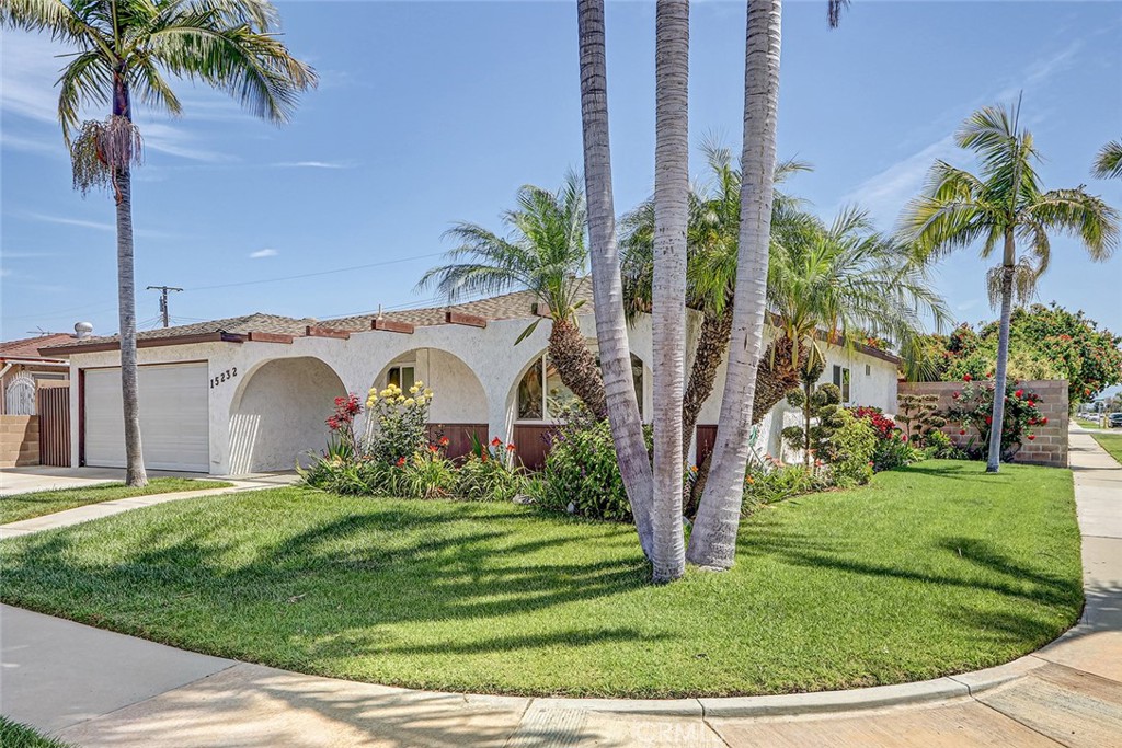 15232 Purdy Street Westminster, CA 92683 - Photo 10 of 31 a view of a white house with a big yard and palm trees
