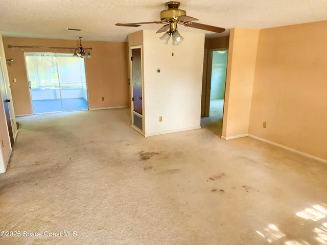 an empty room with closet and windows