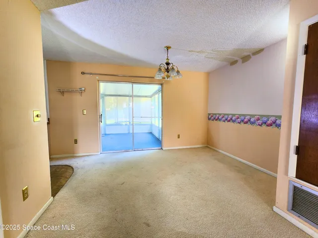 a hallway with white cabinets and wooden floor