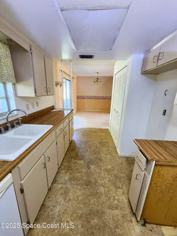 a utility room with wooden floor washer and dryer