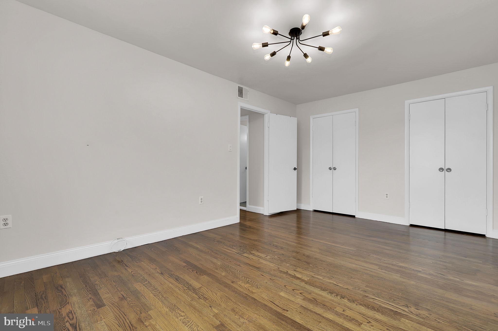 11514 Bucknell Drive, Unit 202 Silver Spring, MD 20902 - Photo 15 of 31 a view of an empty room with wooden floor
