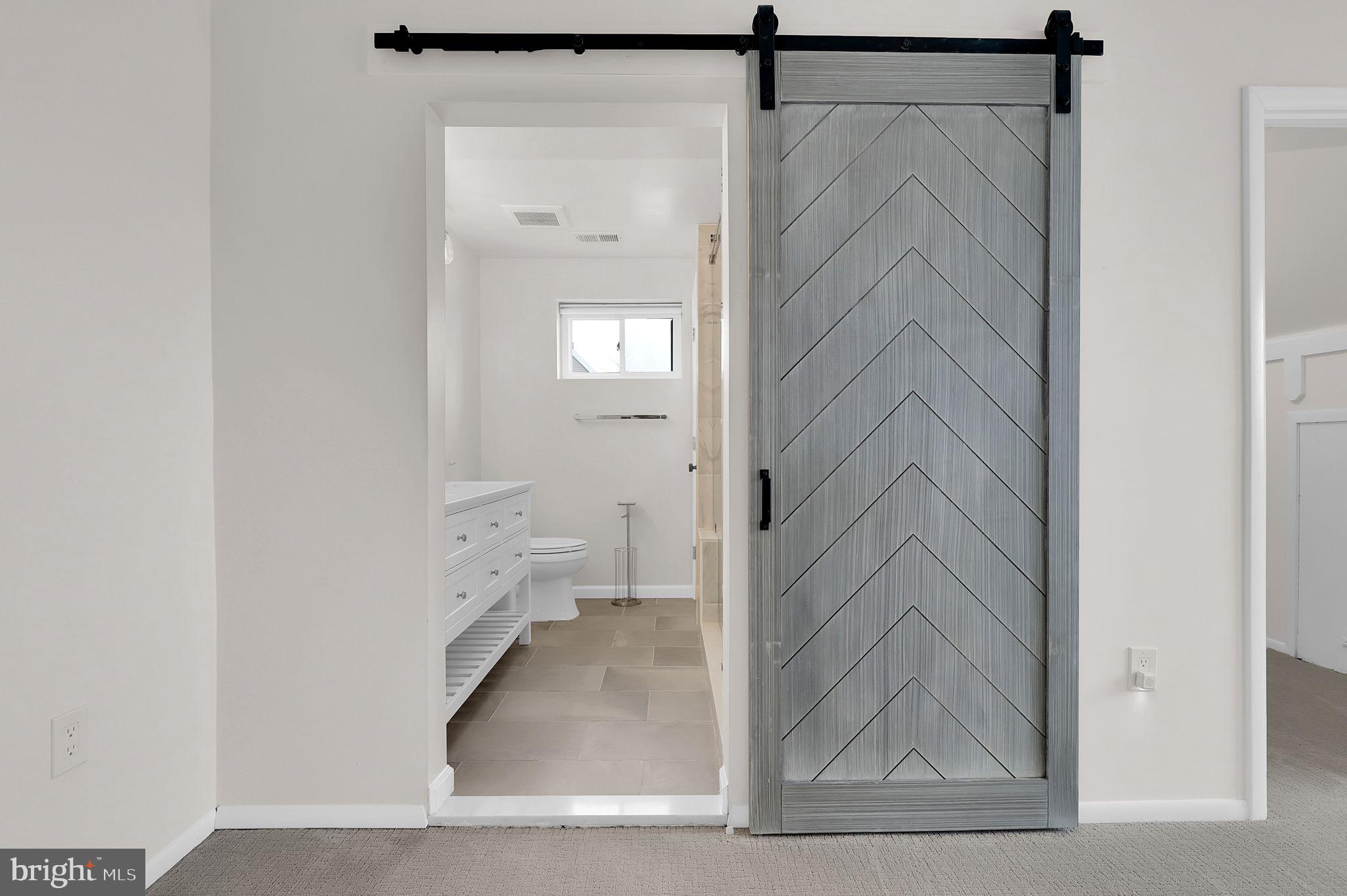 11514 Bucknell Drive, Unit 202 Silver Spring, MD 20902 - Photo 23 of 31 a view of a bathroom from a hallway