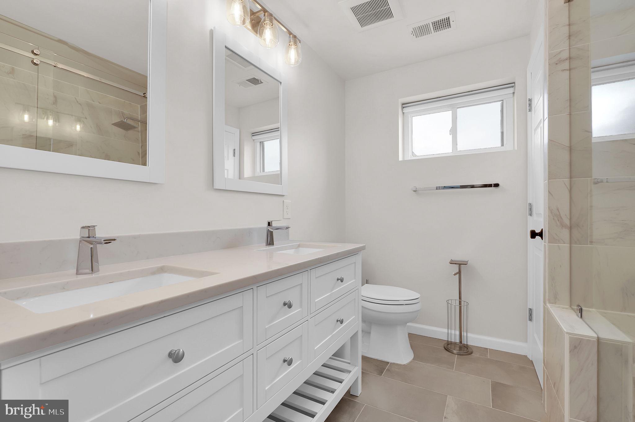 11514 Bucknell Drive, Unit 202 Silver Spring, MD 20902 - Photo 24 of 31 a bathroom with a toilet sink and mirror