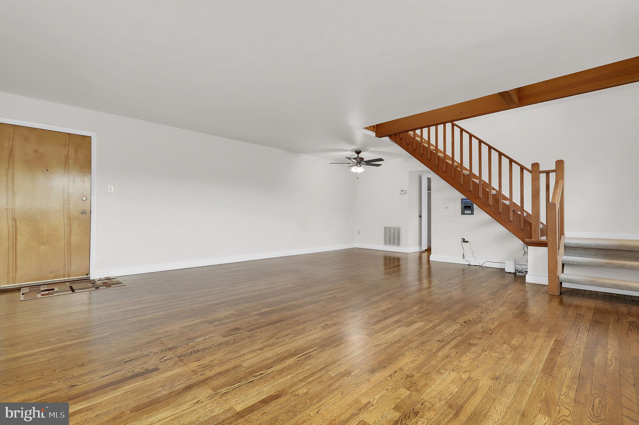 11514 Bucknell Drive, Unit 202 Silver Spring, MD 20902 - Photo 4 of 31 a view of a room with wooden floor and stairs
