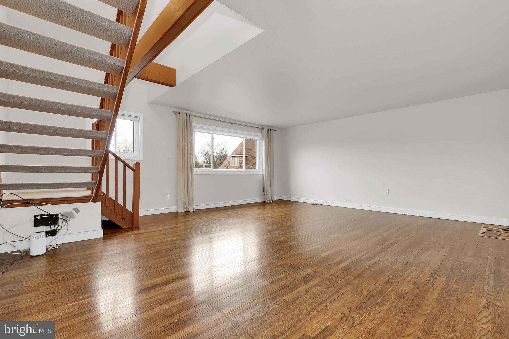 11514 Bucknell Drive, Unit 202 Silver Spring, MD 20902 - Photo 5 of 31 wooden floor in an empty room with a window