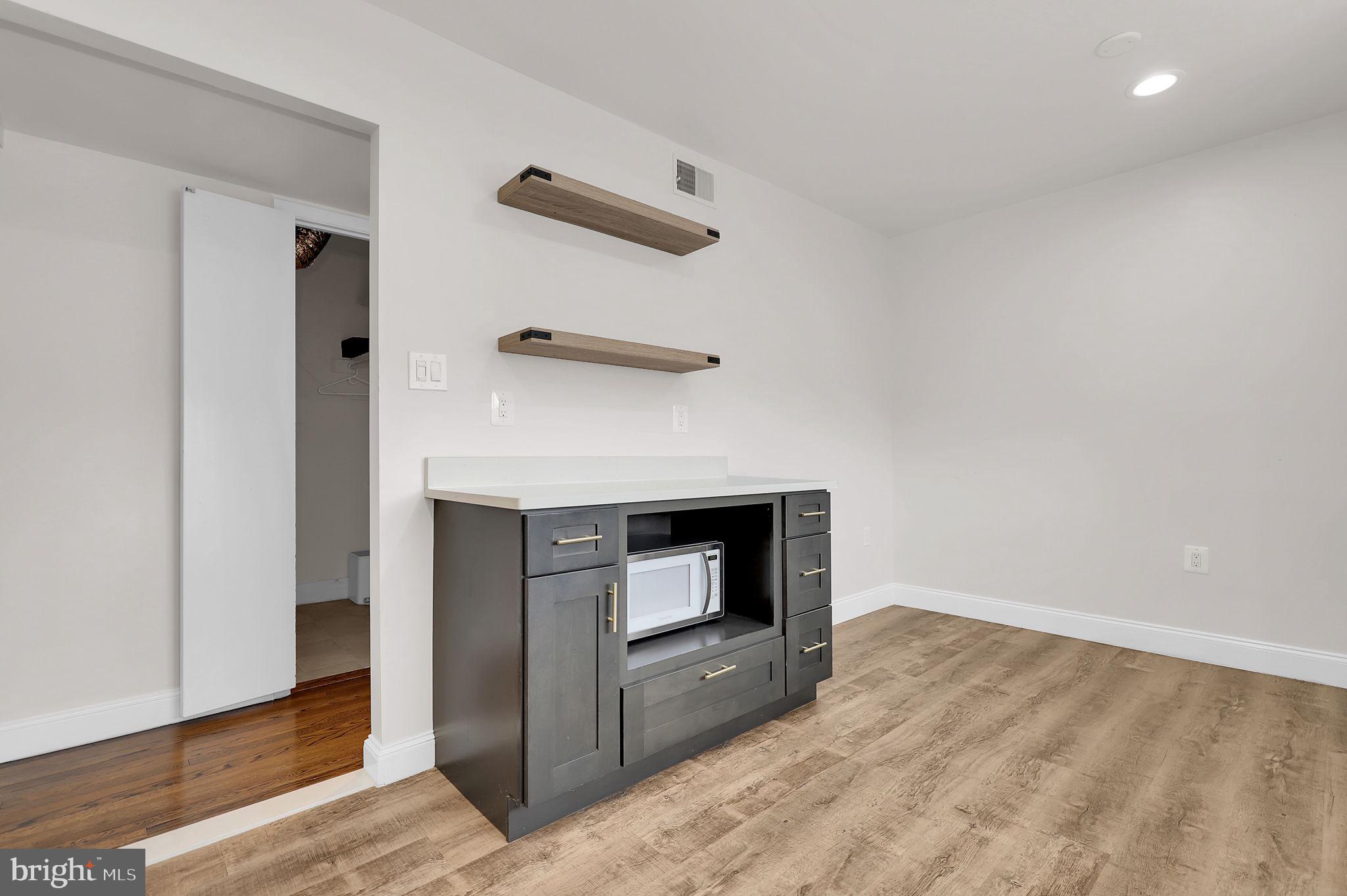 11514 Bucknell Drive, Unit 202 Silver Spring, MD 20902 - Photo 8 of 31 a room with a fireplace and wooden floor