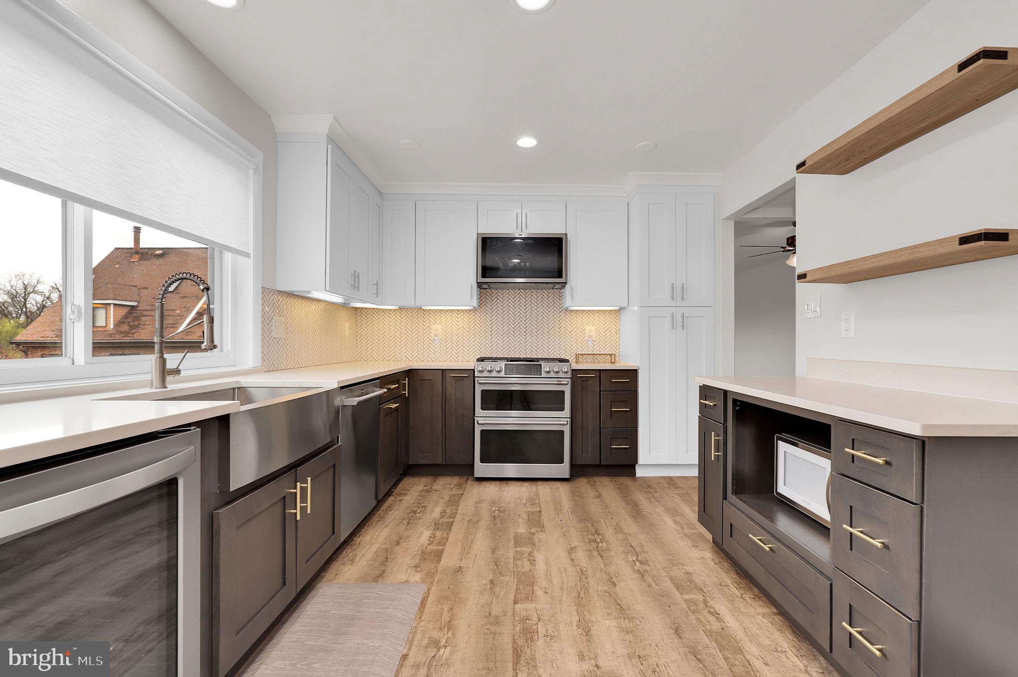 11514 Bucknell Drive, Unit 202 Silver Spring, MD 20902 - Photo 9 of 31 a kitchen with stainless steel appliances a stove sink and cabinets