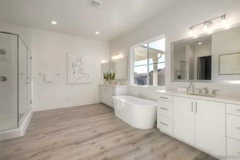 a bathroom with a shower and a glass door