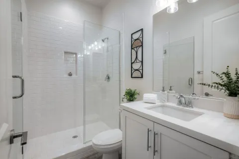 a bathroom with a toilet a sink and shower