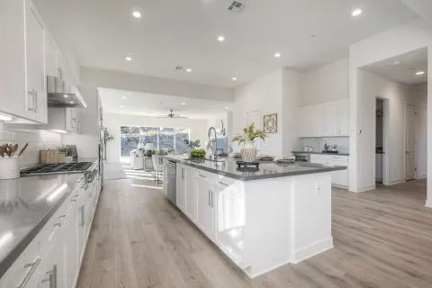 a kitchen with sink stove and cabinets