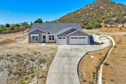 an aerial view of a house with a swimming pool