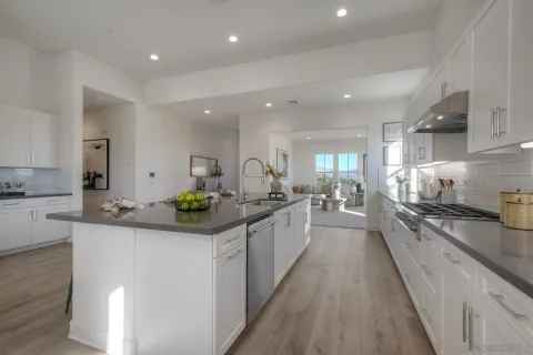 a kitchen with stainless steel appliances kitchen island granite countertop a sink and cabinets