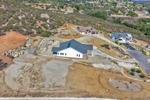 an aerial view of a houses with a yard