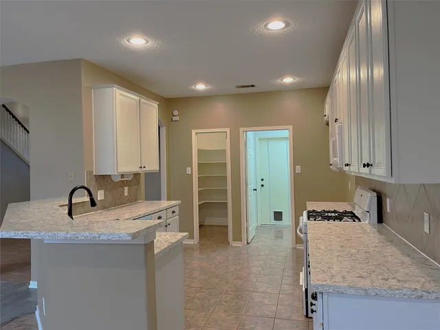 a kitchen with stainless steel appliances granite countertop a sink and cabinets